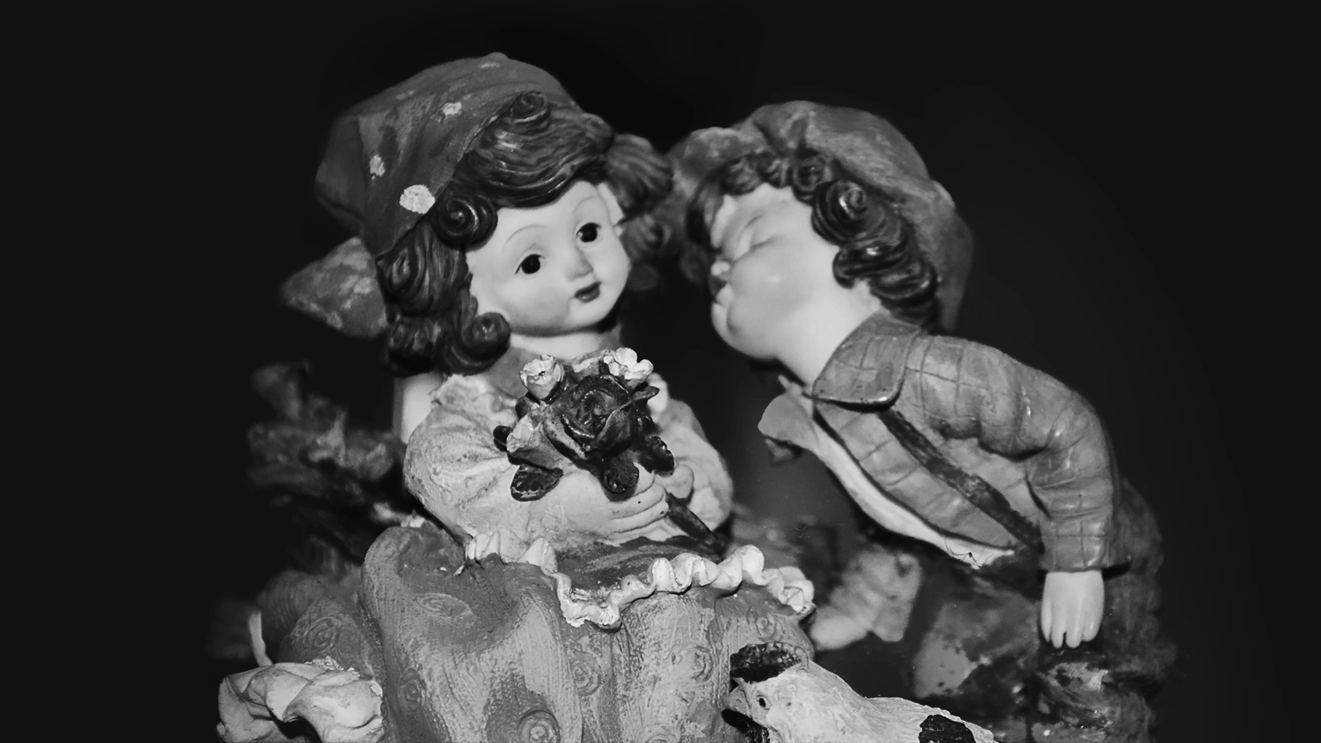 Decorative figure holding a rose